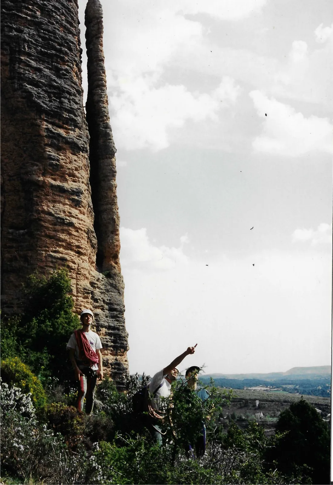 Photographie argentique ancienne : grimpeurs au pied de colonnes de grès