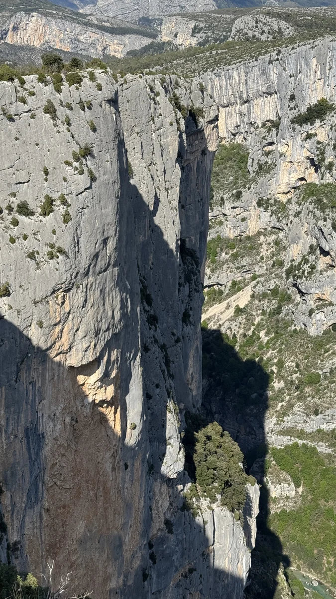 Pilier calcaire avec grimpeur en progression, lumière latérale